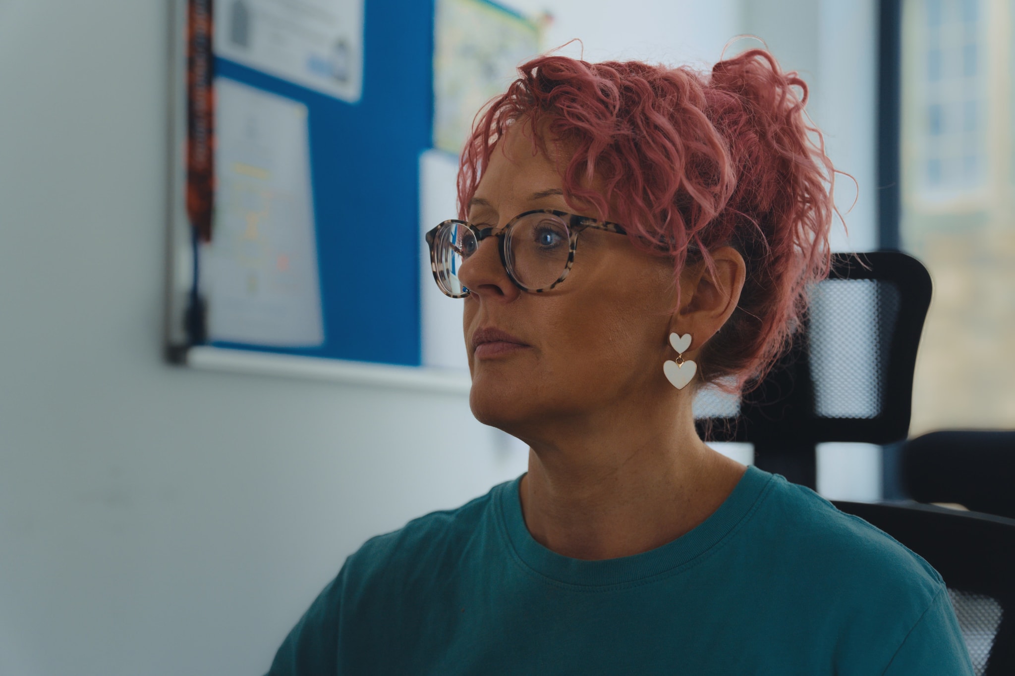 An Unmasked team member listening carefully in a bright office