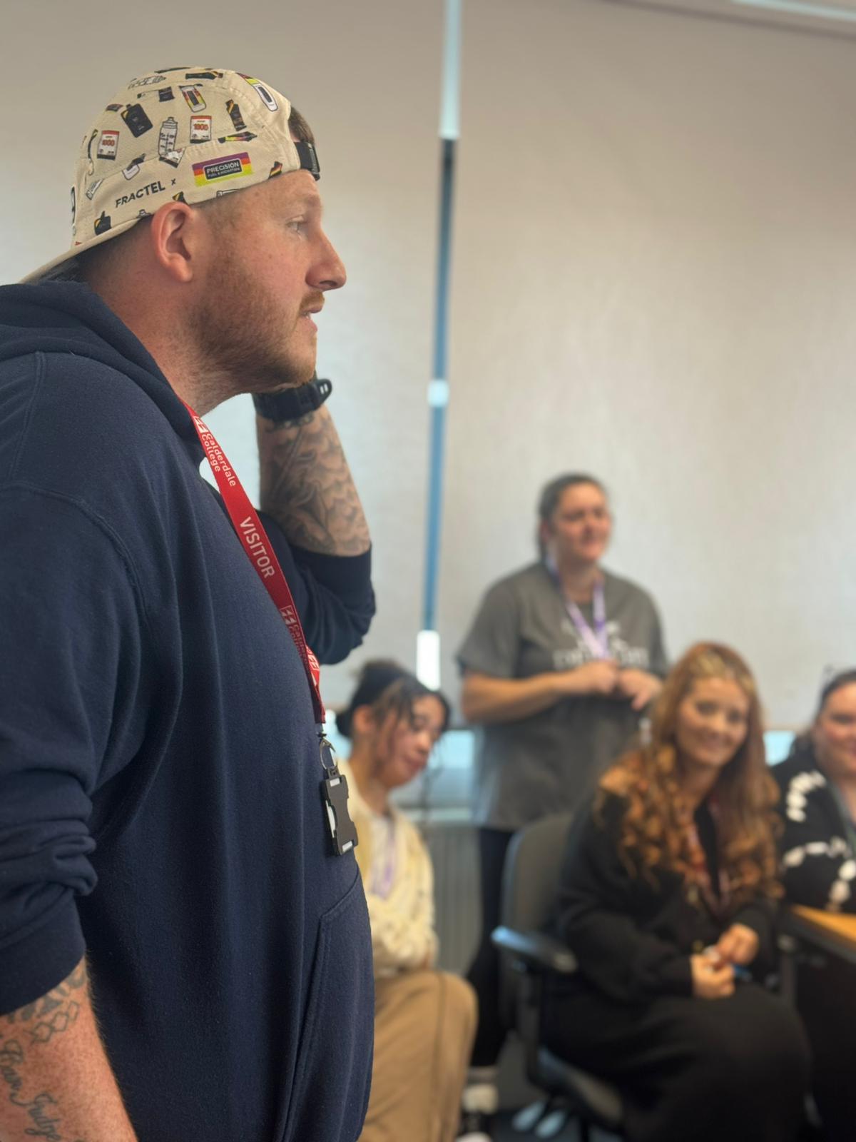 An Unmasked speaker delivering a free wellbeing talk to an employer group