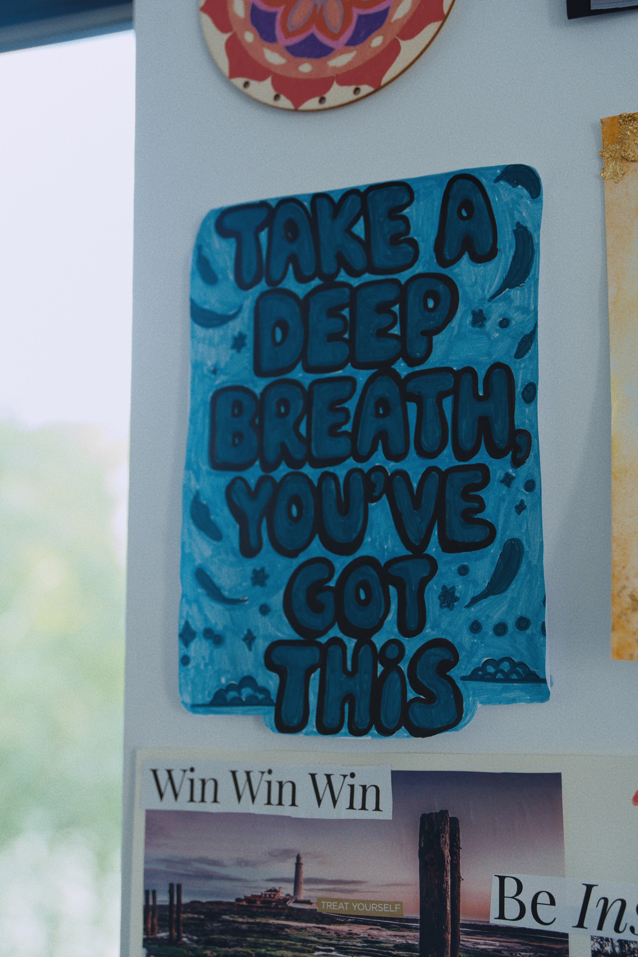Artwork from Unmasked mental health art sessions displayed on the wall