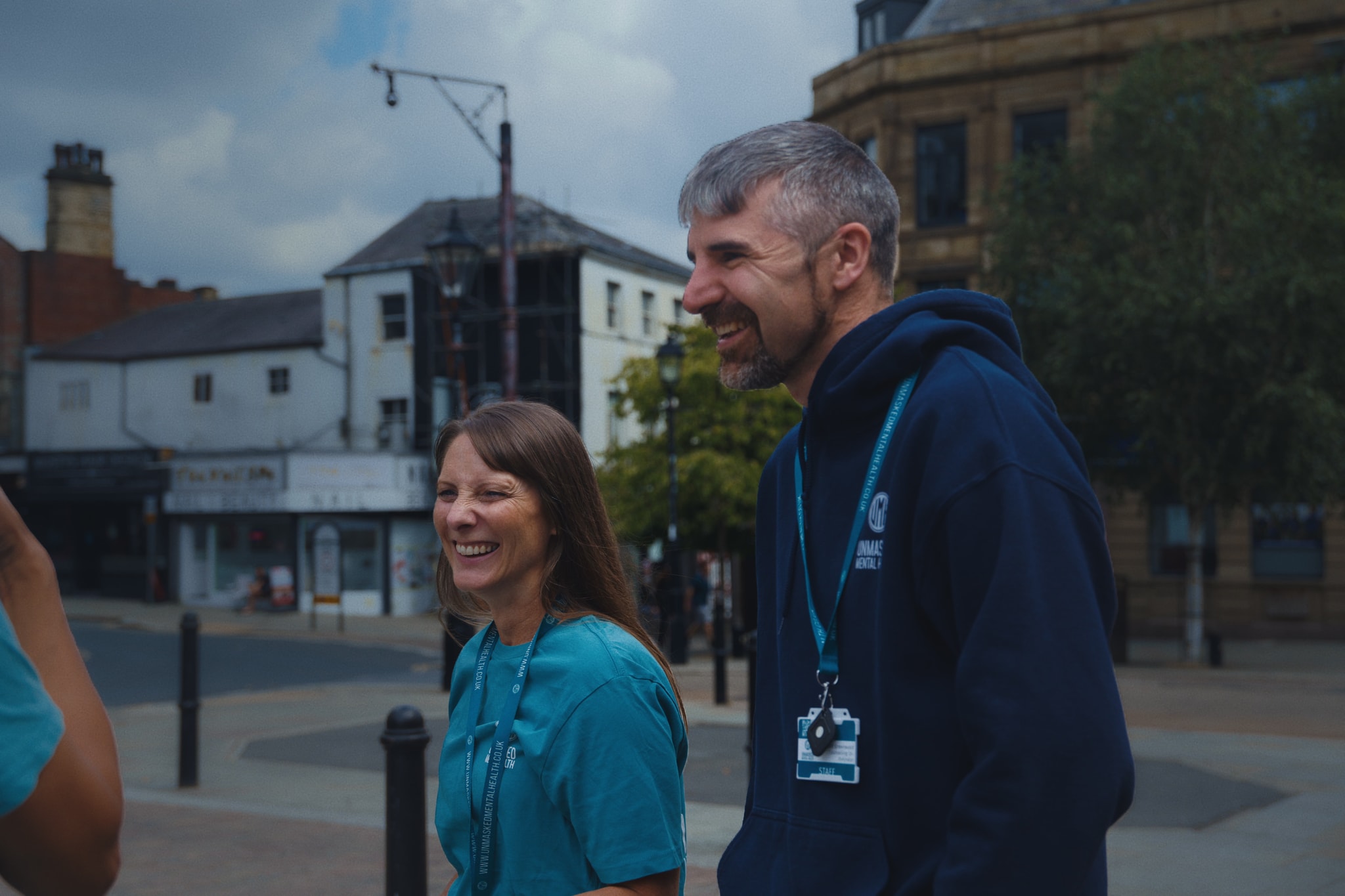 Two Unmasked counsellors laughing and smiling together outdoors in Halifax