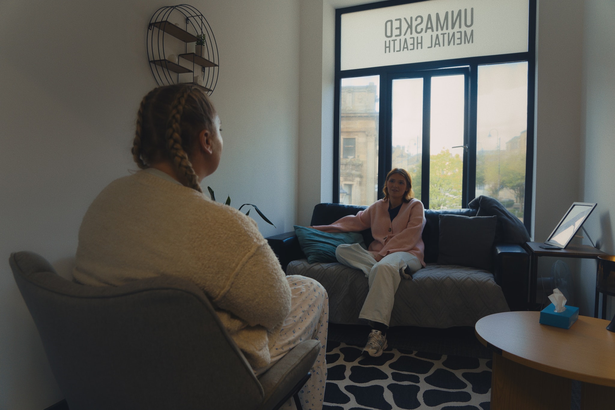 Two people in a cosy Unmasked counselling room during a daytime session