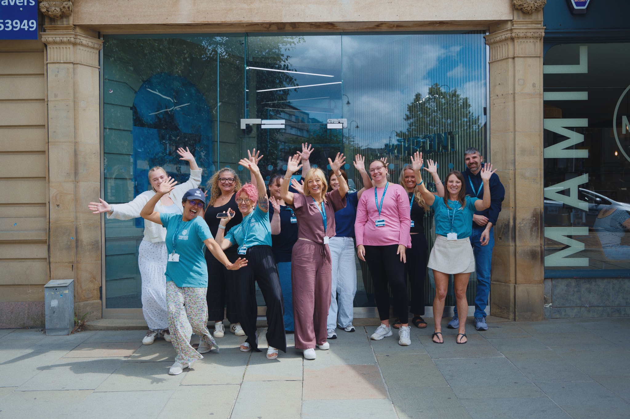 The Unmasked Mental Health team smiling and waving outside their Halifax base