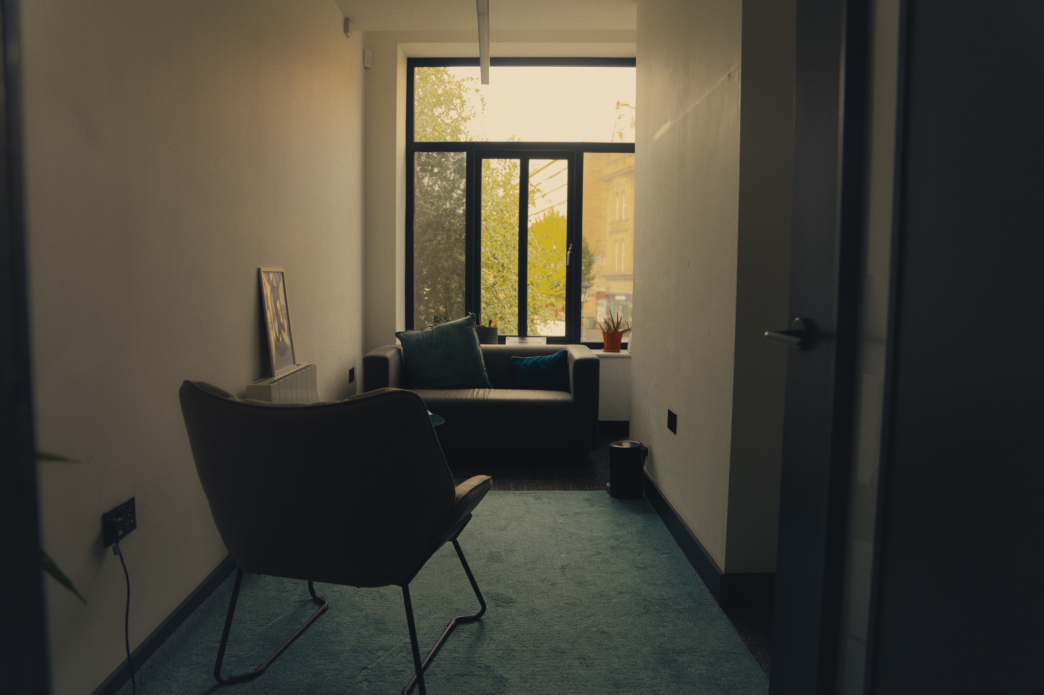 A calm, private Unmasked counselling room with soft natural light